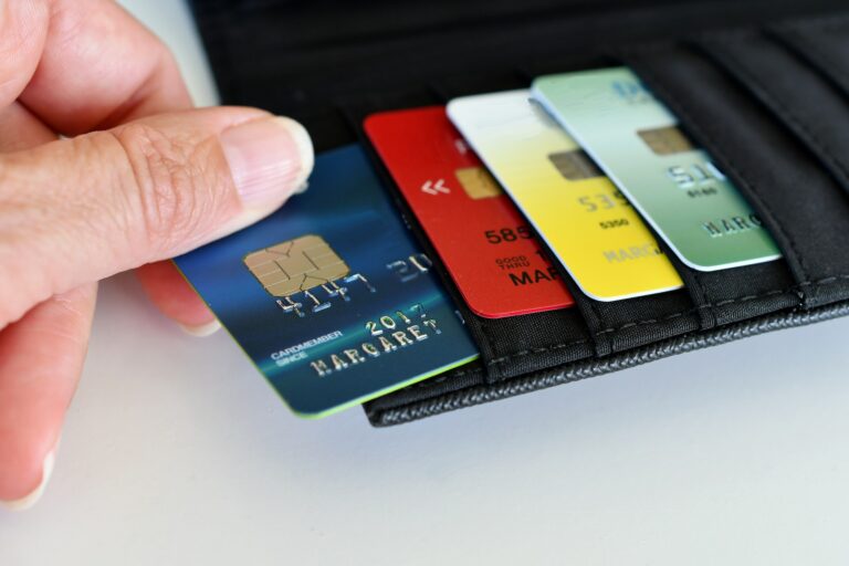 Credit Cards - Pulling a credit card out of wallet for shopping, spending, purchasing, credit rating