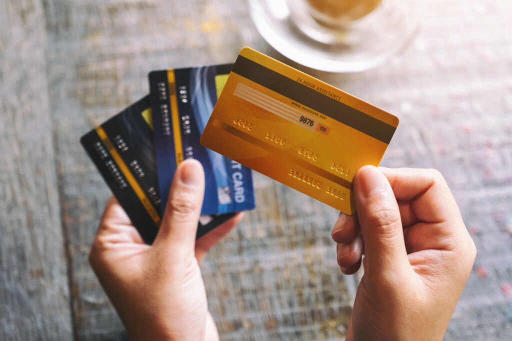 Top view image of a woman holding and showing credit cards