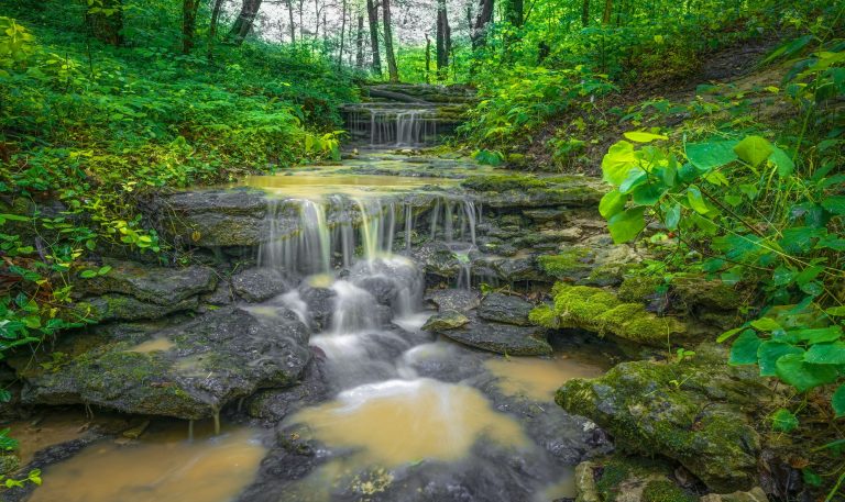 Long exposure waterfall flowing over rocky surface in Cherokee Park, Louisville, Kentucky, USA