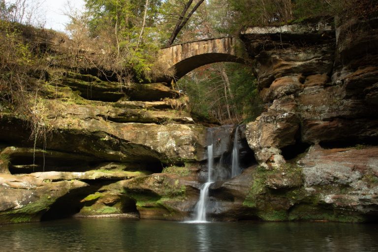 Small waterfall with a stone bridge in Hocking Hills State Park, Ohio